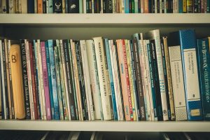 A decorative picture of books on a bookshelf.